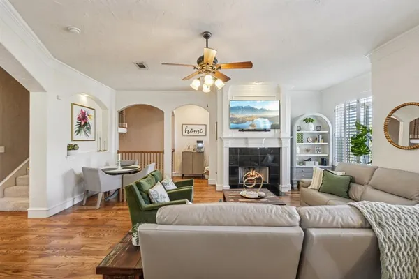 a living room with furniture a fireplace and a chandelier