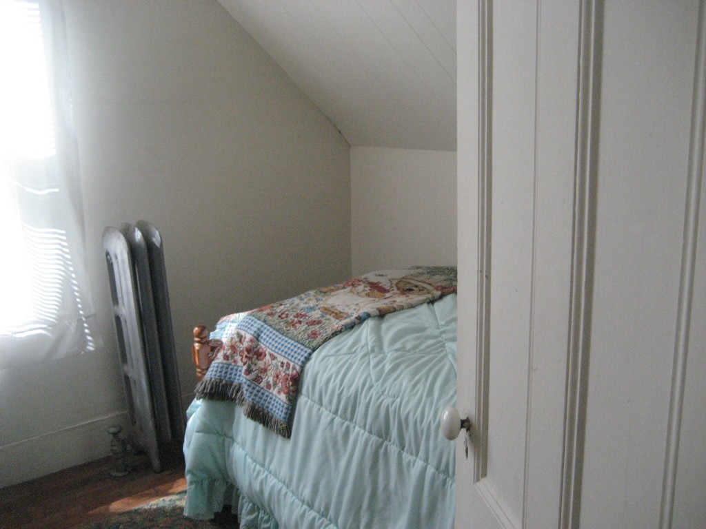11 Clinton Street Everett, MA 02149 - Photo 14 of 25 a bed sitting in a bedroom next to a window