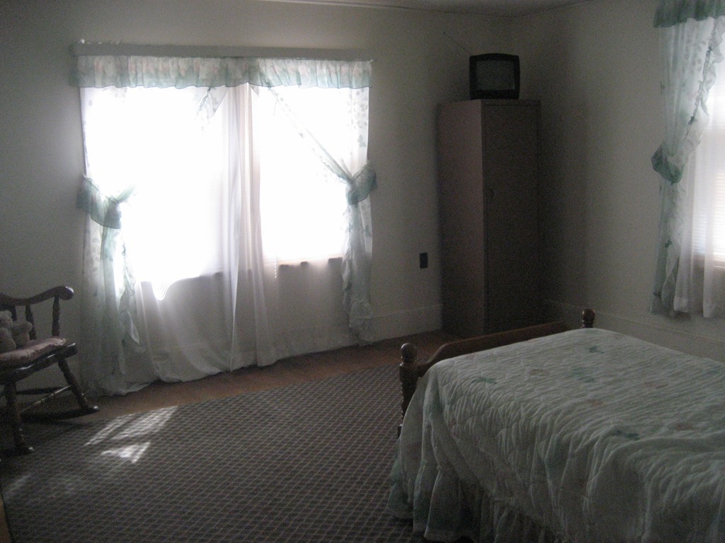 11 Clinton Street Everett, MA 02149 - Photo 16 of 25 a bed sitting in a bedroom next to a window