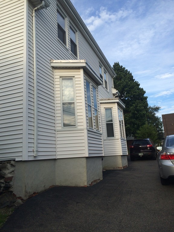 11 Clinton Street Everett, MA 02149 - Photo 4 of 25 a view of a house with a yard