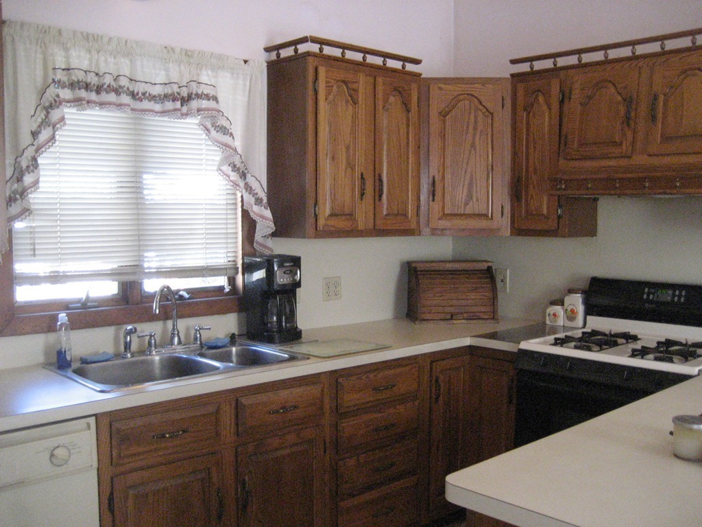 11 Clinton Street Everett, MA 02149 - Photo 7 of 25 a kitchen with a sink a stove and cabinets