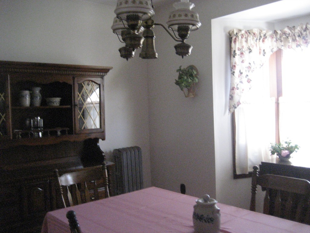 11 Clinton Street Everett, MA 02149 - Photo 9 of 25 a bedroom with a bed table and chair