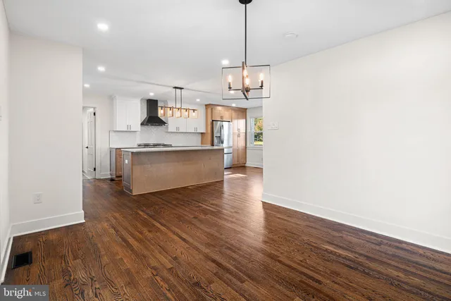 a view of a kitchen with a dishwasher and wooden floor