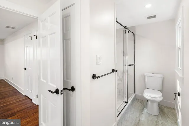 a bathroom with a toilet and a shower