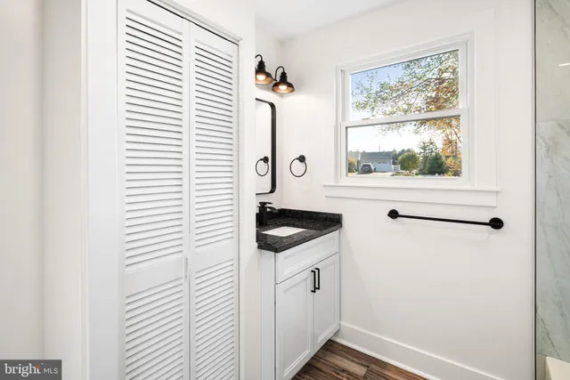 a bathroom with a sink and a window