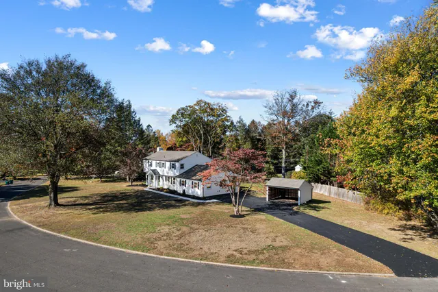 a view of a swimming pool with lawn chairs and a fire pit