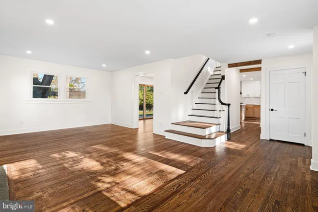 a view of a room with wooden floors and stairs