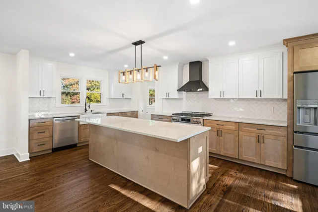 a kitchen with stainless steel appliances a sink stove and refrigerator