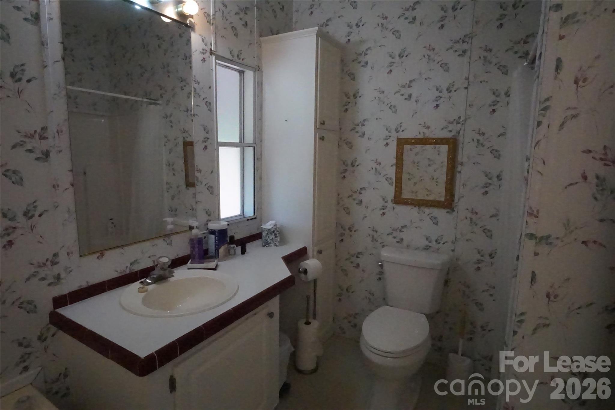 4550 Lee Cline Road Conover, NC 28613 - Photo 11 of 17 a bathroom with a granite countertop toilet sink and mirror