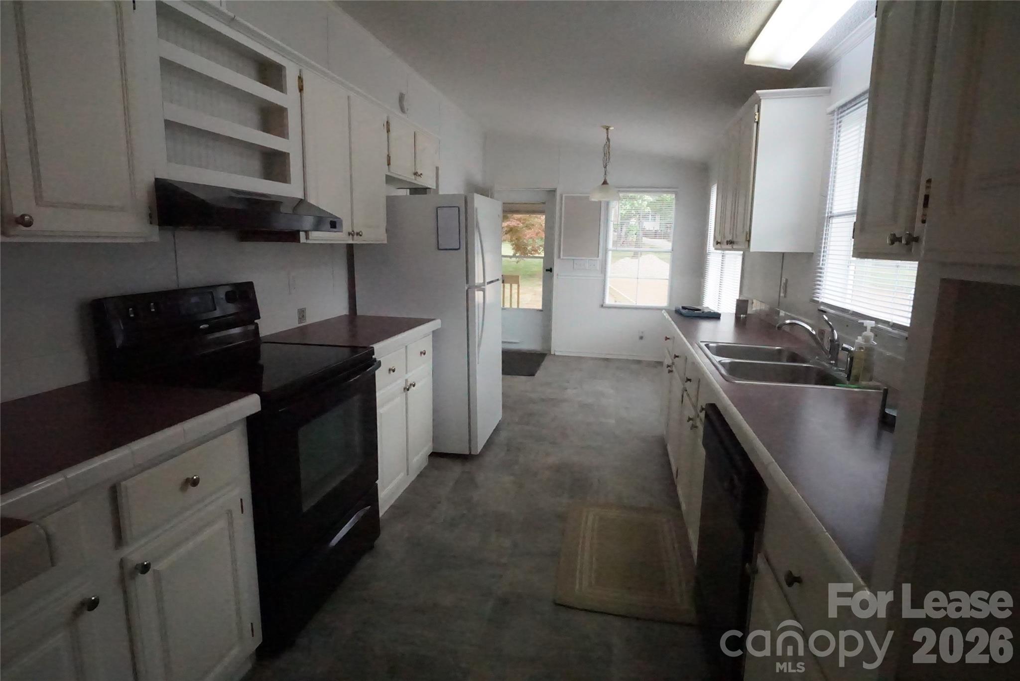 4550 Lee Cline Road Conover, NC 28613 - Photo 7 of 17 a kitchen with stainless steel appliances granite countertop a stove a sink and a refrigerator