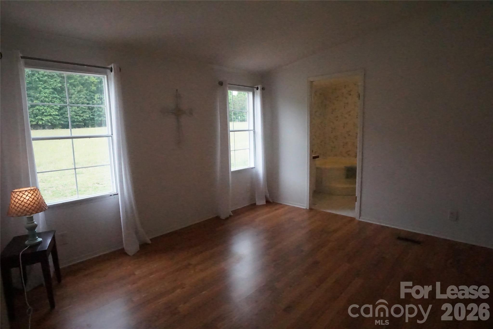 4550 Lee Cline Road Conover, NC 28613 - Photo 9 of 17 an empty room with wooden floor and windows