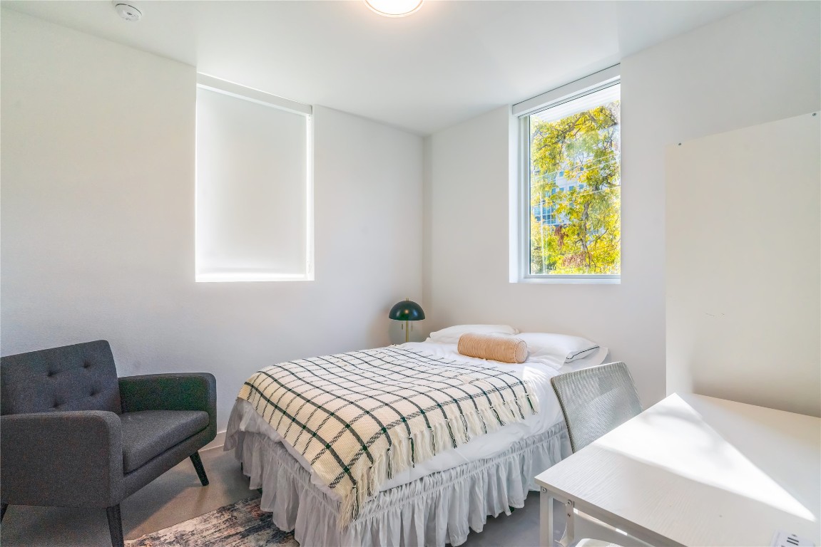 a bedroom with a bed and a window