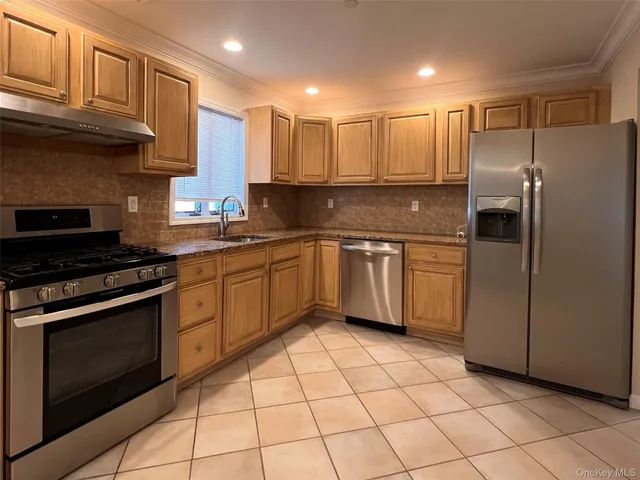 a kitchen with a sink stainless steel appliances and cabinets