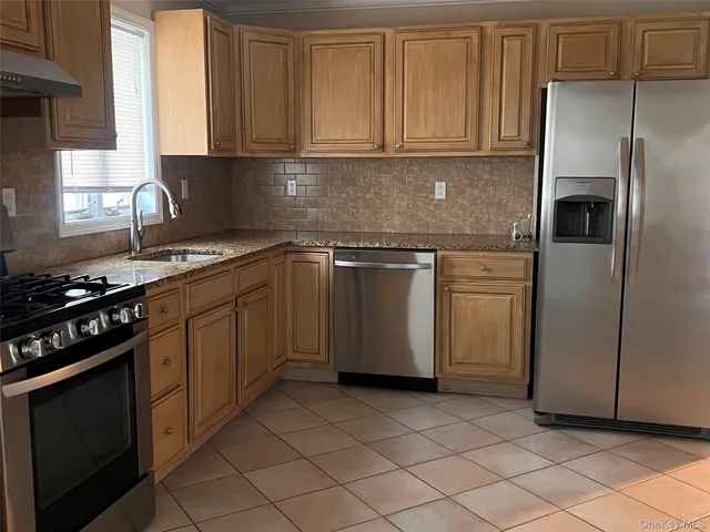 a kitchen with a sink stove and refrigerator