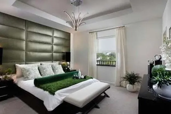 a living room with furniture potted plant and kitchen appliances
