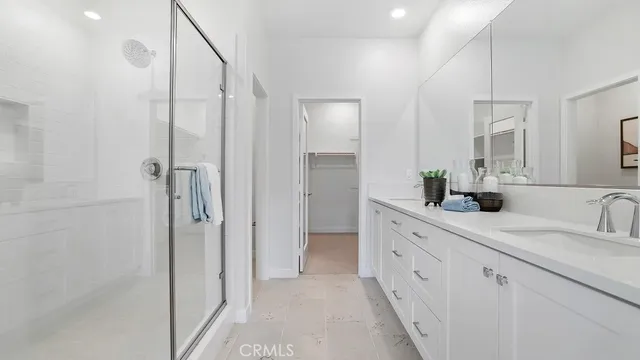 a walk in closet with view of bathroom
