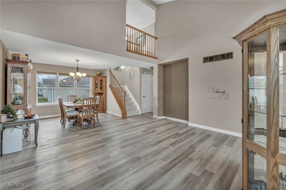 3887 Reeves Lane Medina, OH 44256 - Photo 11 of 42 Unfurnished dining area with light wood-type flooring and an inviting chandelier