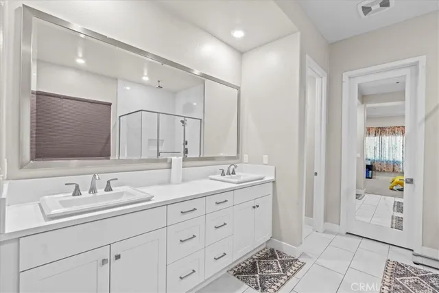 a bathroom with double sink and a mirror