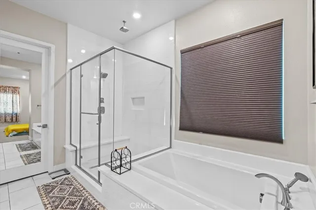 a bathroom with a bathtub and a shower