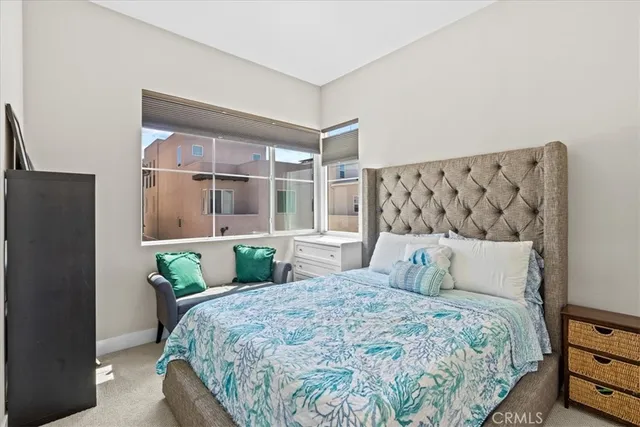 a bedroom with a large bed and a tv