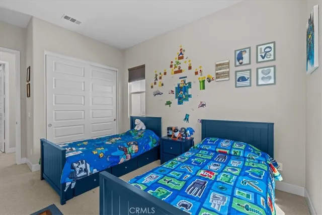 a bedroom with two beds and a dresser