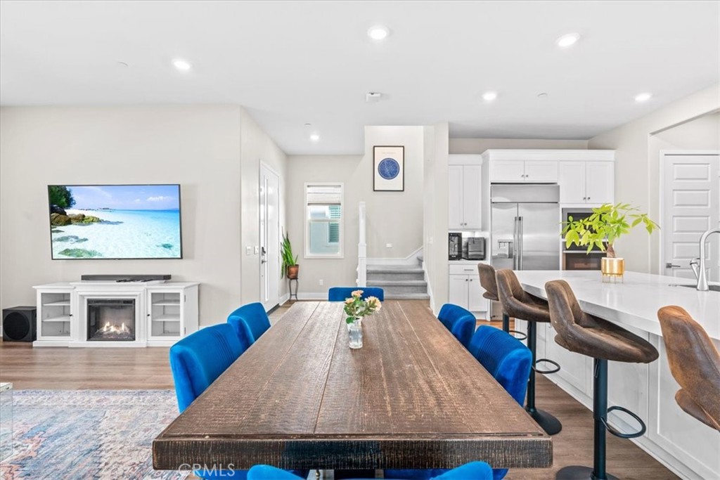 113 Source Irvine, CA 92618 - Photo 8 of 38 a living room with furniture a flat screen tv and kitchen view