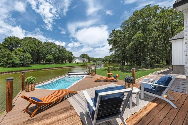 a view of a patio with swimming pool and furniture
