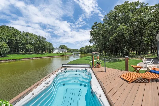 a view of lake with wooden floor and outdoor seating