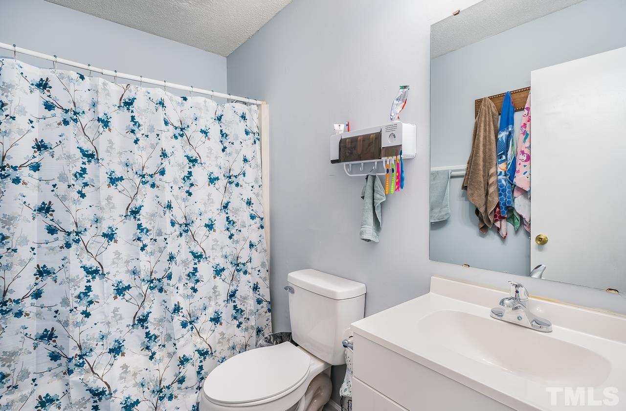 4557 Hargrove Road Raleigh, NC 27604 - Photo 15 of 16 a bathroom with a sink toilet and shower
