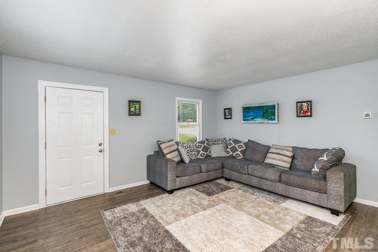 4557 Hargrove Road Raleigh, NC 27604 - Photo 7 of 16 a living room with furniture and a wooden floor