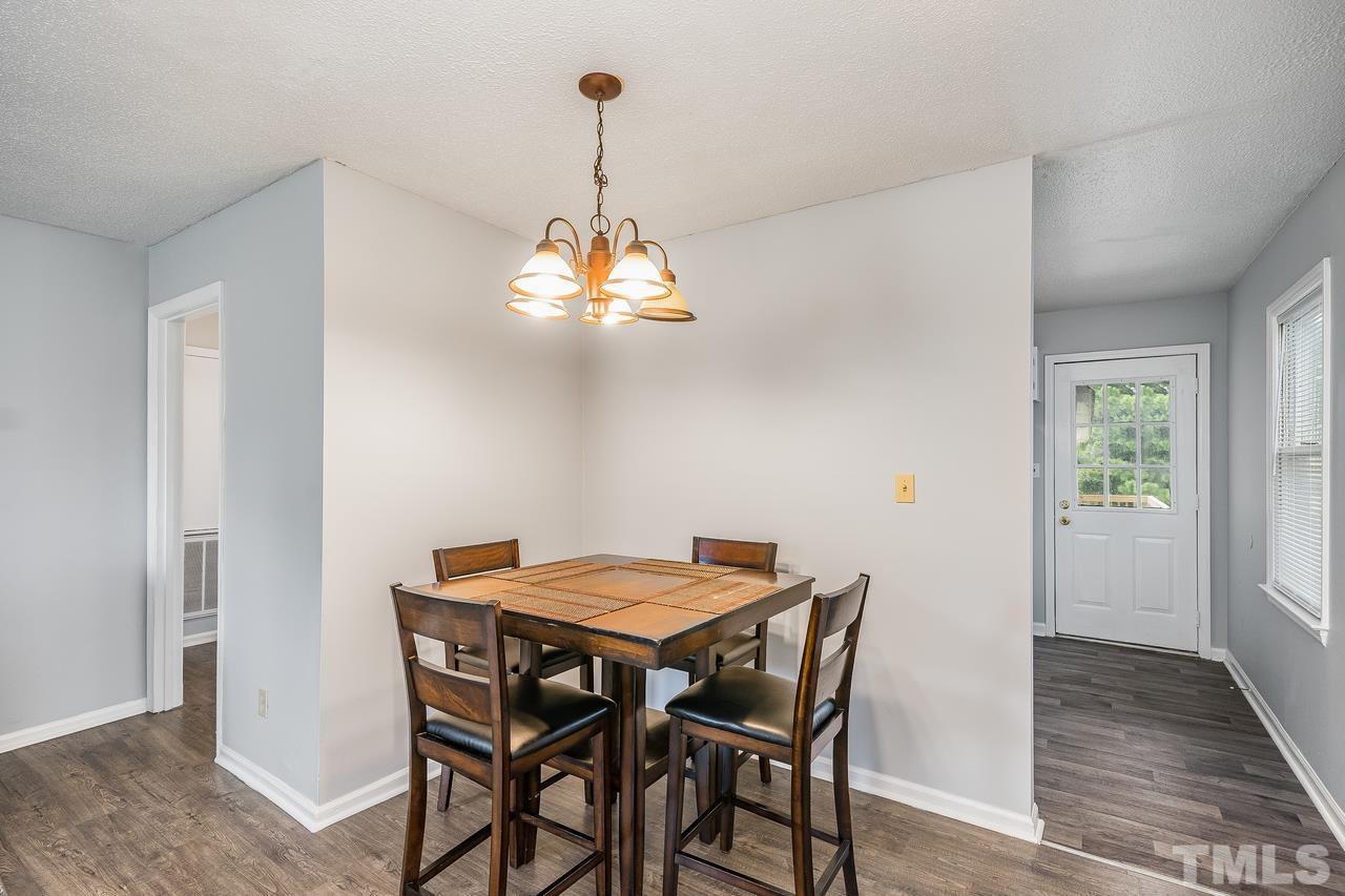 4557 Hargrove Road Raleigh, NC 27604 - Photo 8 of 16 a view of a dining room with furniture and chandelier