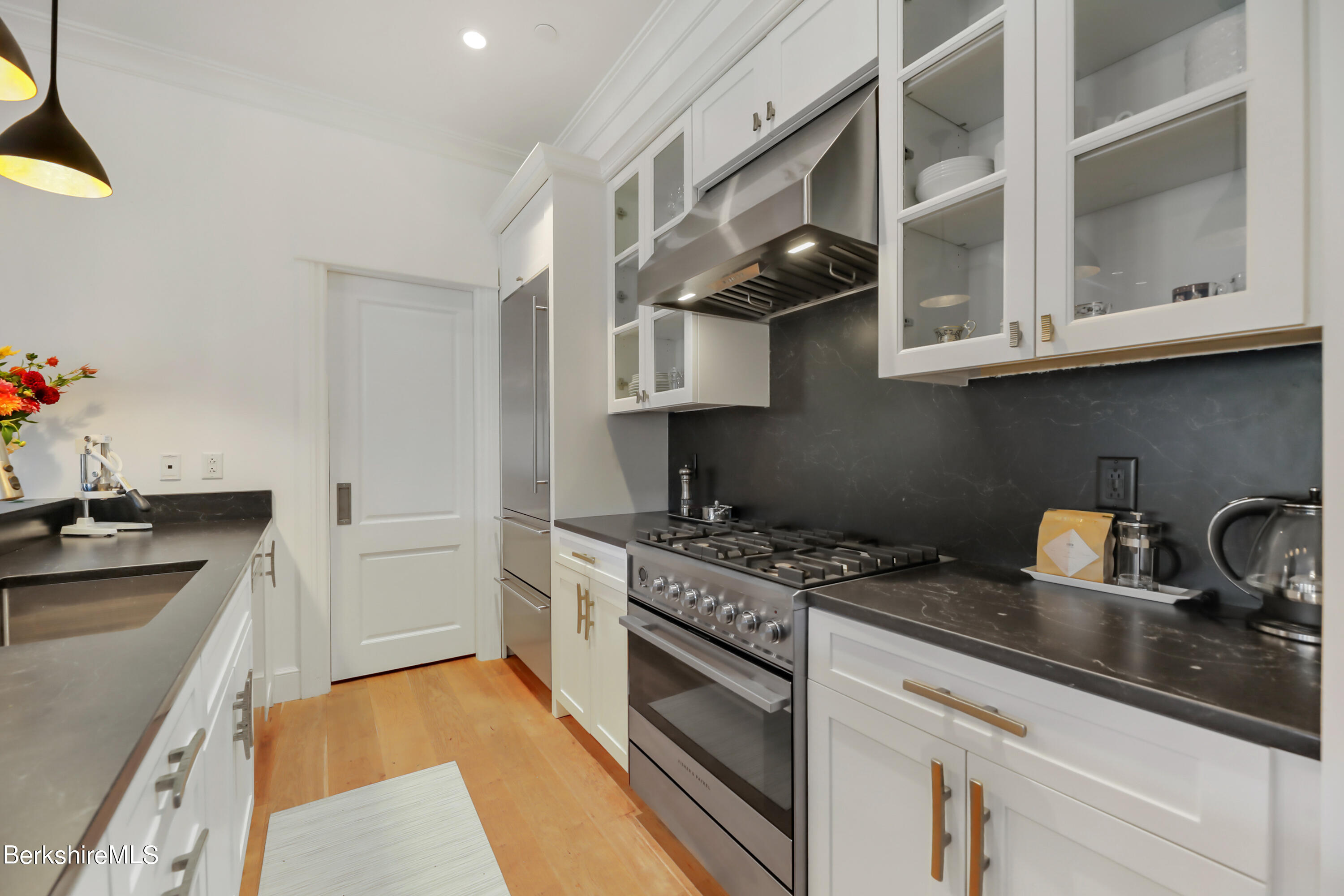 165 Kemble Street, Unit 16 Lenox, MA 01240 - Photo 14 of 31 a kitchen with stainless steel appliances granite countertop a sink stove and cabinets