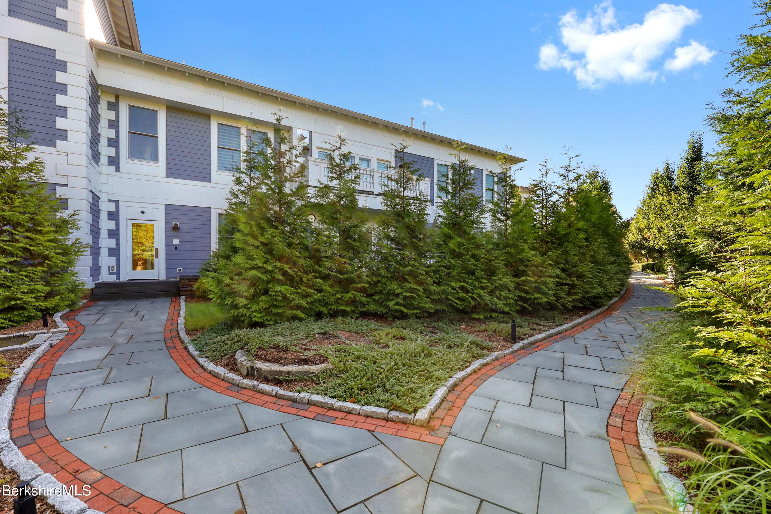 165 Kemble Street, Unit 16 Lenox, MA 01240 - Photo 2 of 31 a view of a garden with a pathway