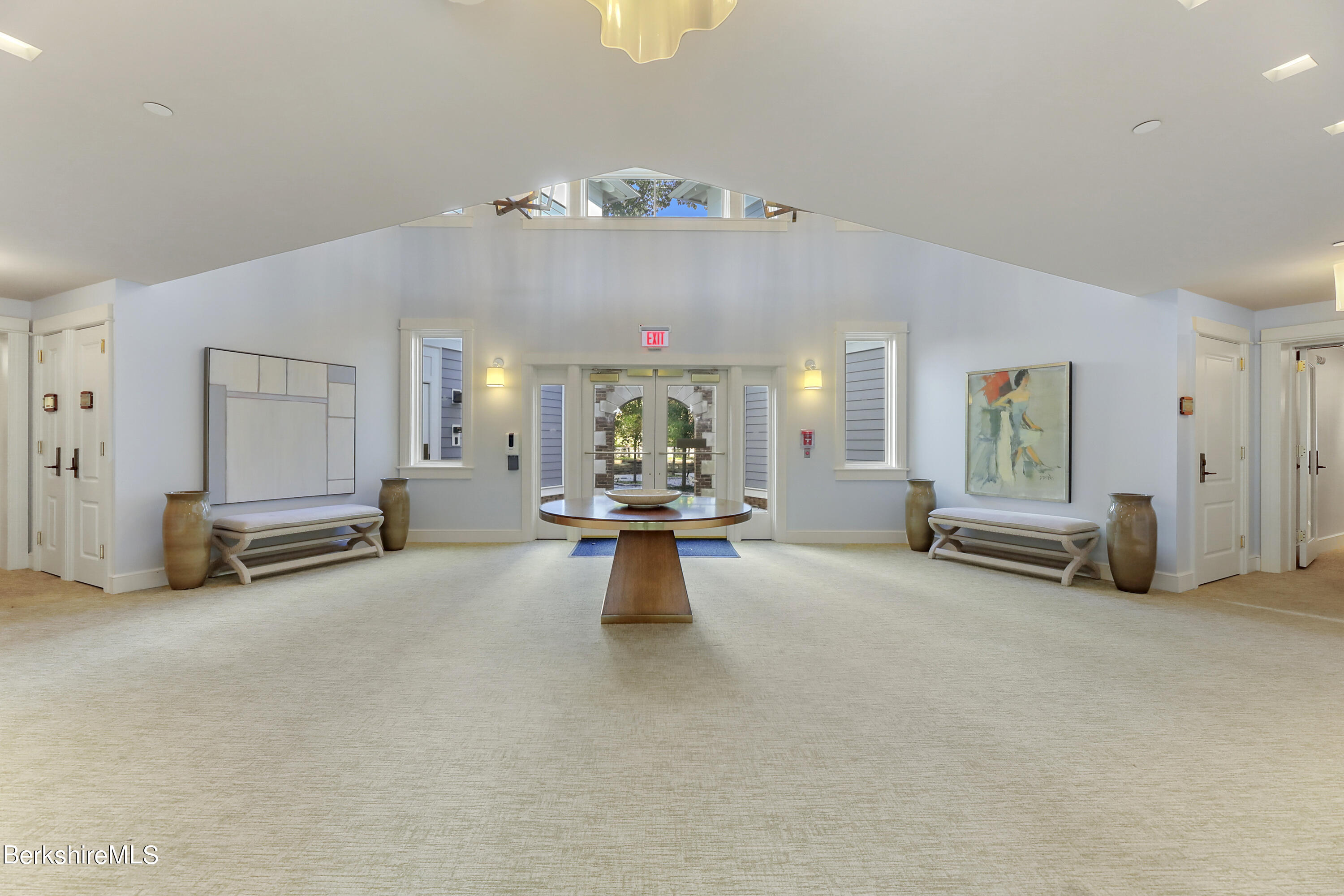 165 Kemble Street, Unit 16 Lenox, MA 01240 - Photo 3 of 31 an empty room with furniture and a chandelier