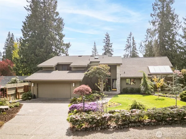 a front view of house with yard and trees