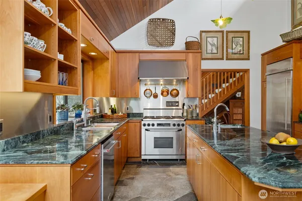 a kitchen with a stove a sink and a counter top space