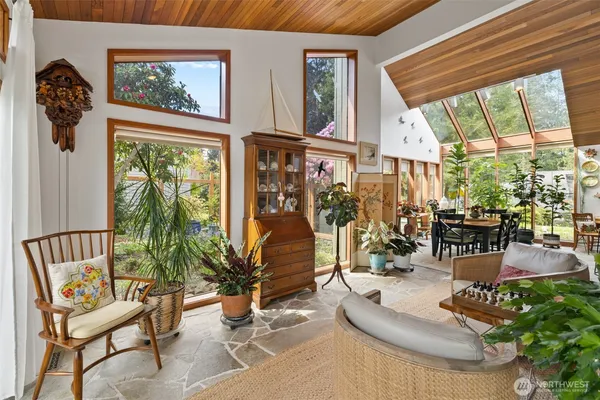 a living room with furniture and a floor to ceiling window