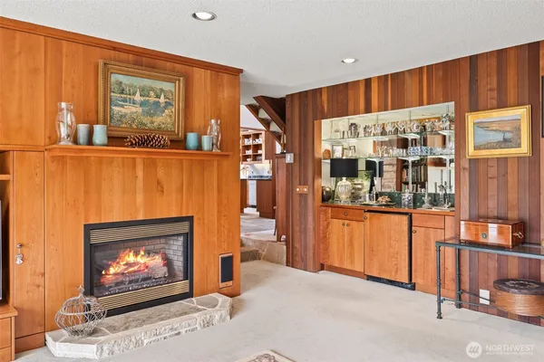a view of open kitchen with fireplace and chandelier