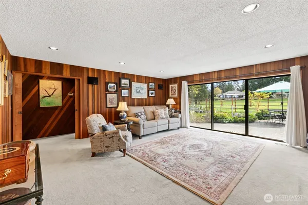 a living room with couch floor to ceiling window and couch