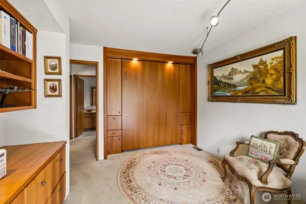 a livingroom with workspace couch and a window
