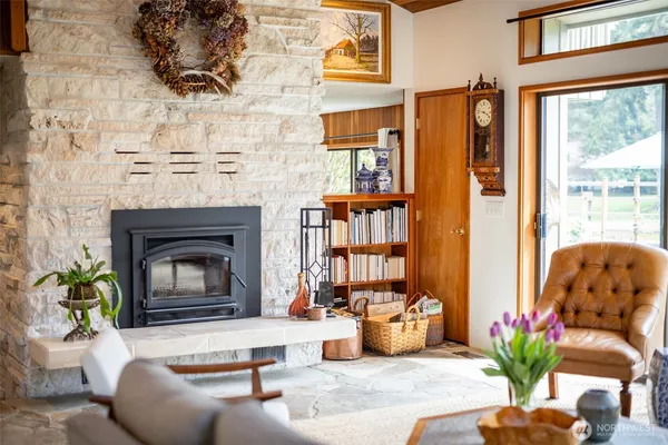 a living room with furniture fireplace and potted plants