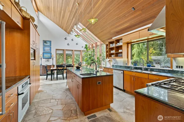 a kitchen with stainless steel appliances granite countertop a stove and cabinets