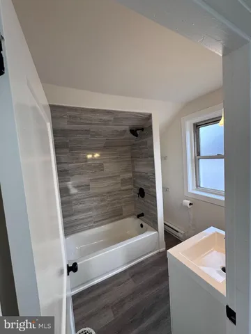 a bathroom with a bathtub and a shower