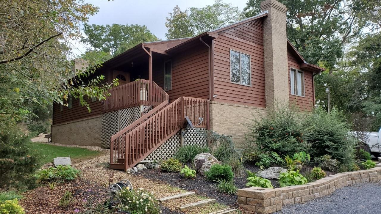 a view of a house with a small yard and a garden
