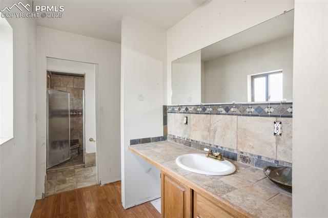 4775 Meridian Road Peyton, CO 80831 - Photo 18 of 25 Primary, vanity, and tasteful backsplash