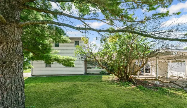 a view of a tree in front of a house
