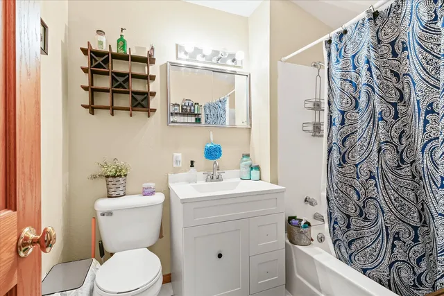 a bathroom with a white sink a vanity and a toilet
