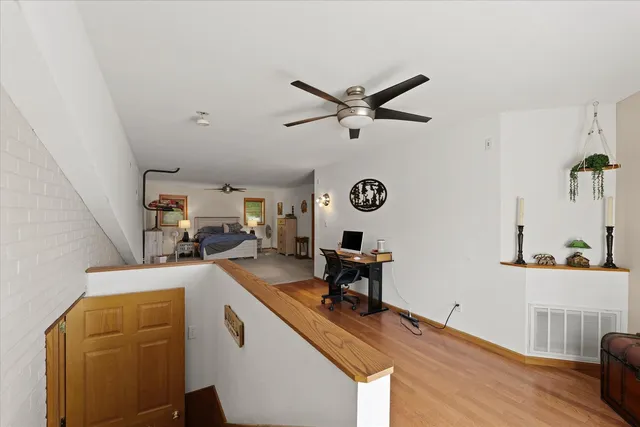 a view of a workspace with furniture and a window