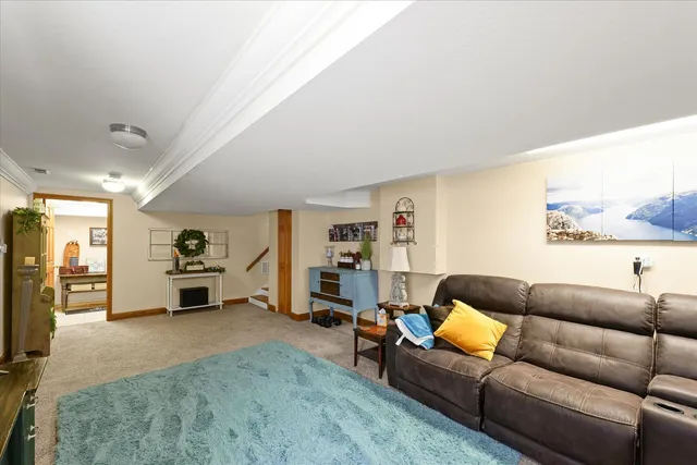 a view of a hallway that has a couch and a table in it