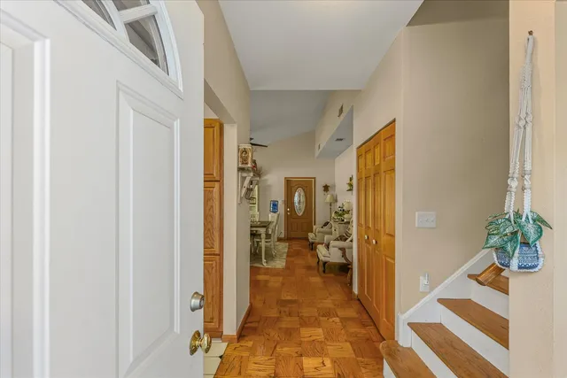 a hallway with a dining table and chairs